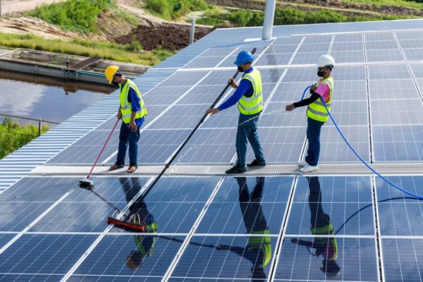 three-workers-cleaning-solar-panels-600x400